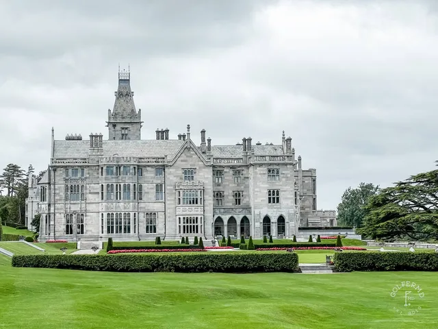 A fairway at Adare Manor, with the manor and trees in the distance.