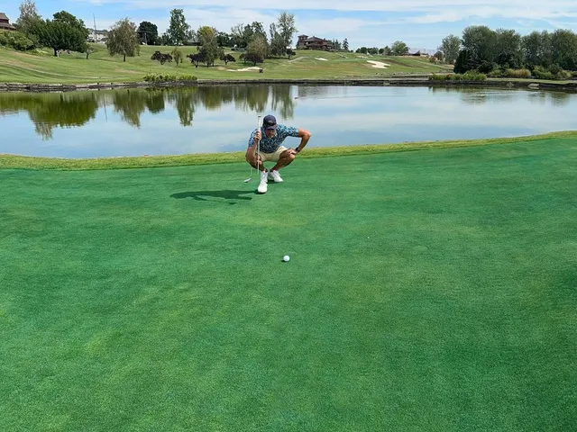 A golfer hitting a shot at Apple Tree, with the fairway ahead.
