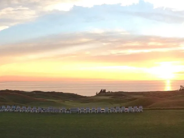 A close view of a flagstick at Arcadia Bluffs, with Lake Michigan behind the green.