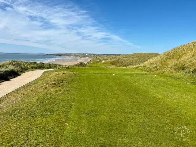 A wide view of the Cashen Course, with dunes and the Atlantic on the horizon.