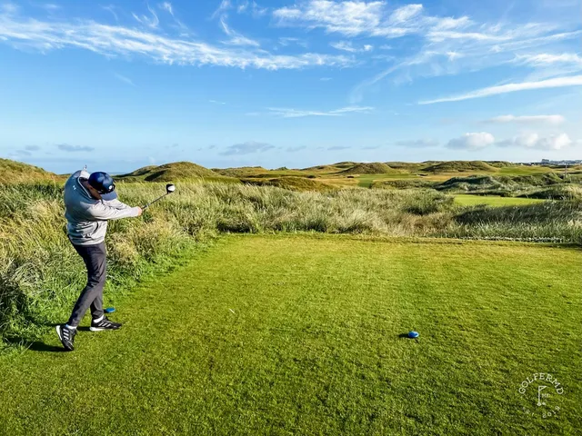 A fairway on the Old Course lined with dunes, running toward the water.