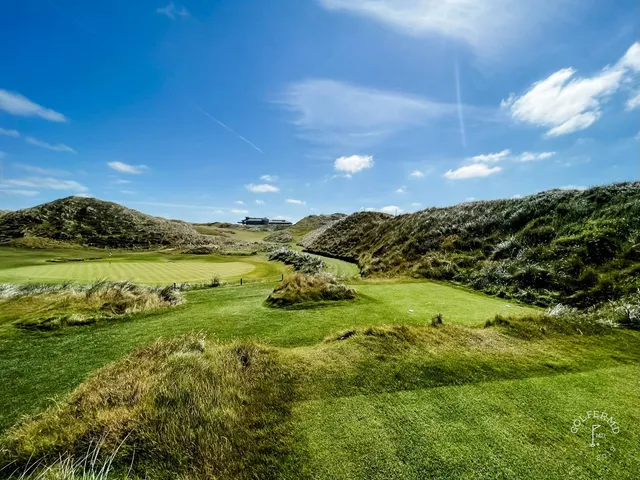 A fairway on the Old Course bending through the dunes toward the ocean.