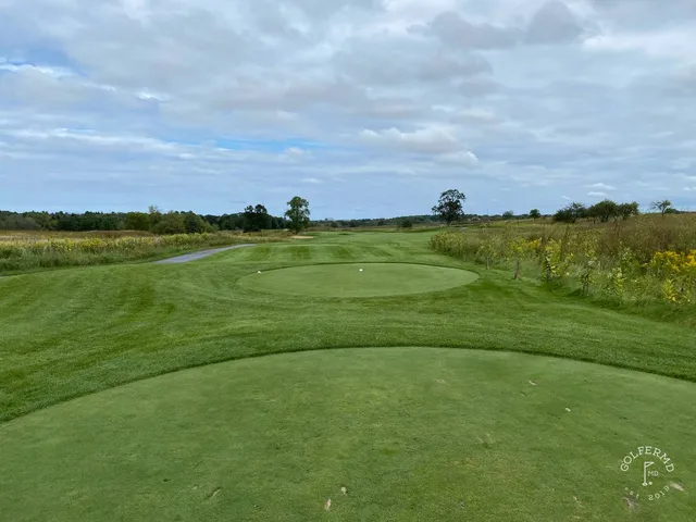 A wide view at Meadow Valleys, with the fairway running through the meadow.