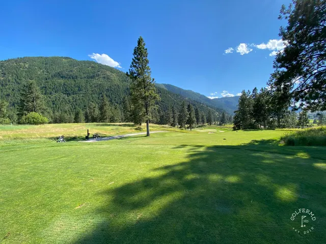 A wide view at Canyon River, with the fairway, trees, and mountains.