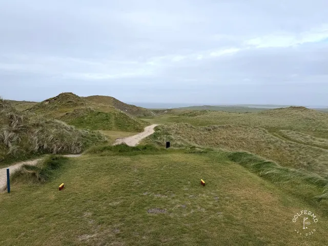 A fairway at Carne lined with dunes, running toward the bay.