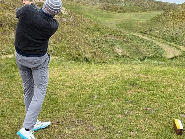 Golfers on a tee at Carne, with the Atlantic behind them.