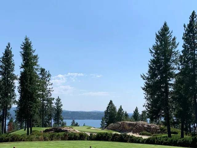 A fairway at The Coeur d'Alene Resort Golf Course, with the lake and mountains beyond the hole.