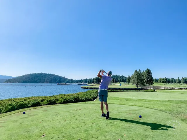 A green and flagstick at the Coeur d'Alene Resort, with the lake behind the hole.