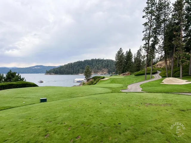 A golfer hitting a shot at the Coeur d'Alene Resort, with the lake ahead.
