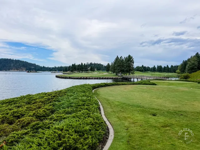 A wide fairway at the resort course, with the lake in the distance.