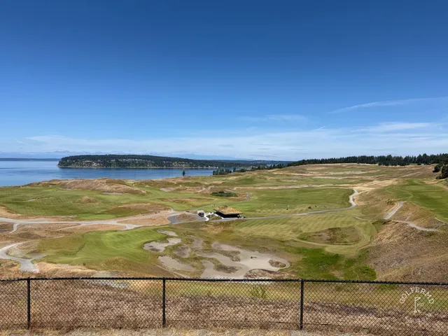 A wide view at Chambers Bay, with the dunes and the sound on the horizon.