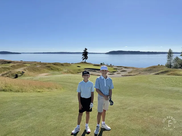 A close view of a flagstick at Chambers Bay, with Puget Sound behind the green.