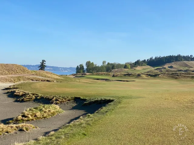 A wide fairway at Chambers Bay dropping toward the sound.