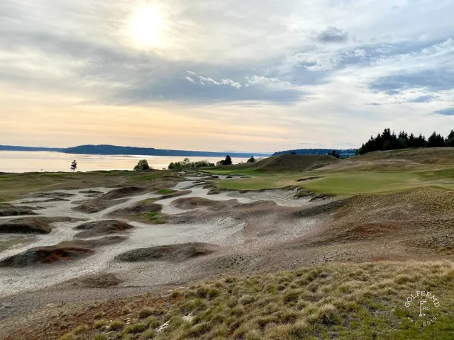 A close view of a flagstick at Chambers Bay, with Puget Sound filling the background.