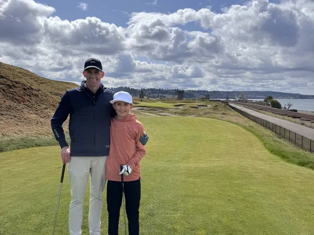 A wide fairway at Chambers Bay running toward the sound, with the sandy dunes along the hole.