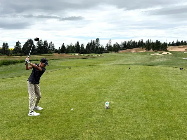 A fairway and green at Circling Raven, with a sand bunker beside the green.