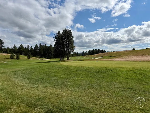 A wide fairway at Circling Raven running between stands of pine.