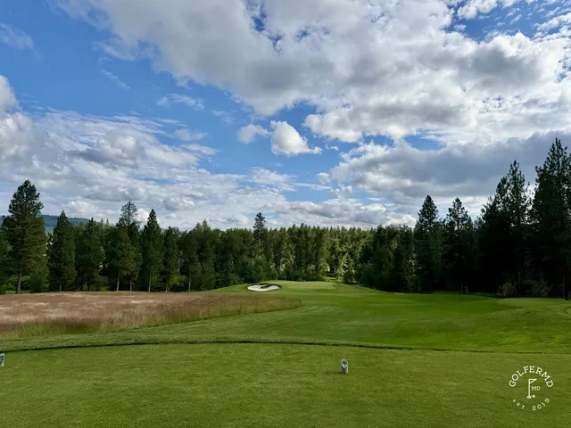 A green and flagstick at Circling Raven, with a deep bunker beside the green.
