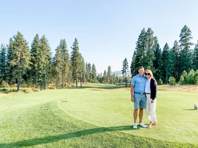 A wide fairway at Circling Raven, with the green raised among the trees.