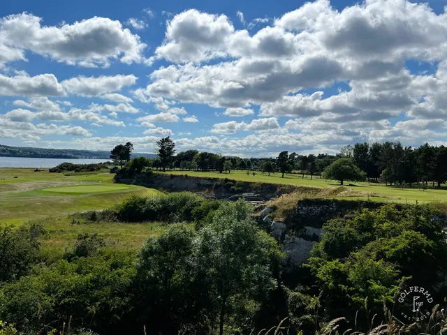 A wide view across Cork Golf Club, with the estuary and the hills.