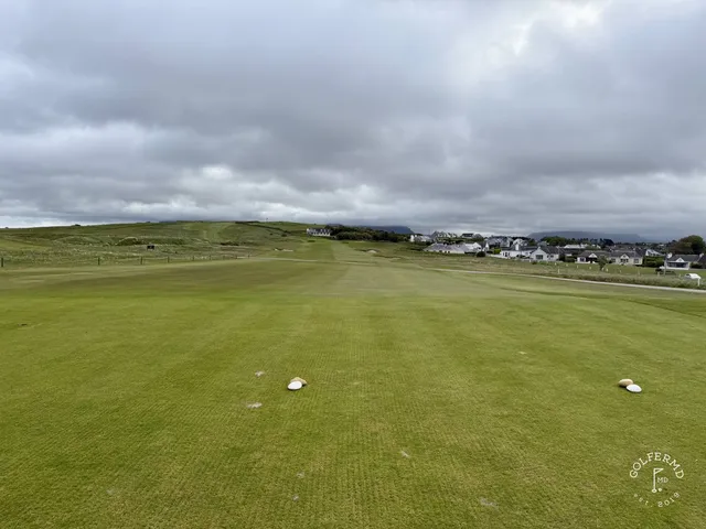 A fairway at County Sligo Golf Club running toward the Atlantic, with Benbulbin in the distance.
