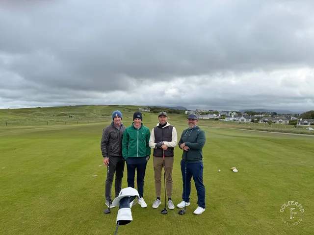 A green and flagstick at Rosses Point, with a bunker in front and the ocean behind the hole.