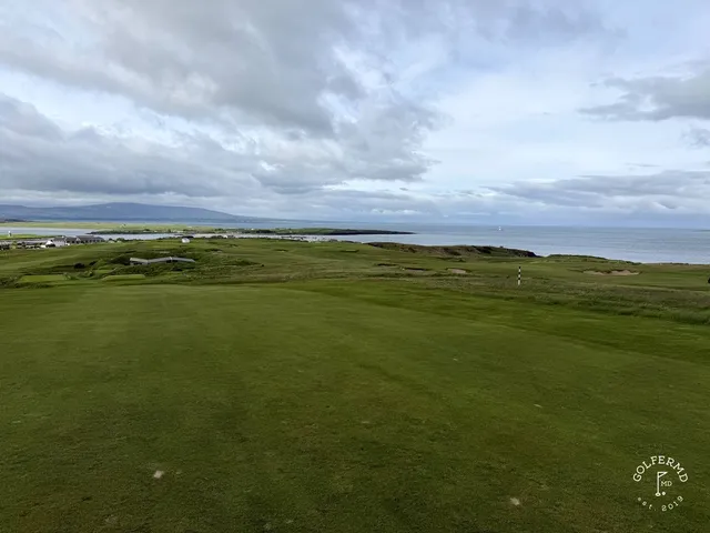 A fairway at County Sligo lined with dunes, running toward the water.