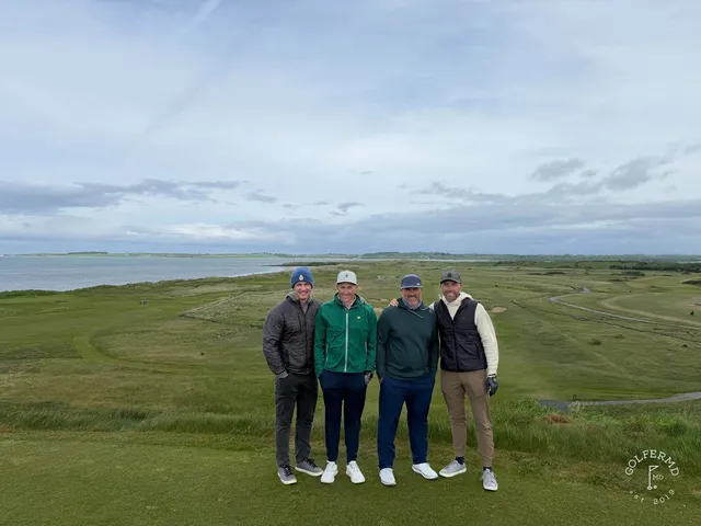 A group of golfers at County Sligo, with the ocean behind them.