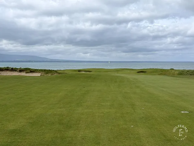Golfers walking a fairway at County Sligo, with the mountain ahead.