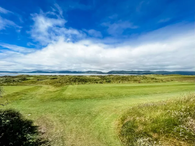 A fairway at Dooks running through the dunes toward the bay.