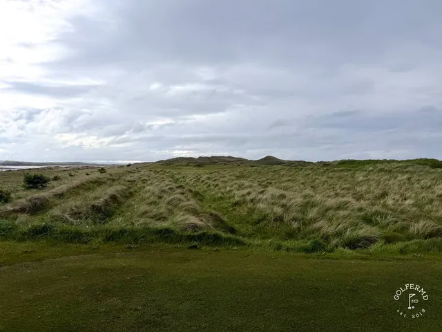 Golfers on a tee at Enniscrone, with the Atlantic behind them.