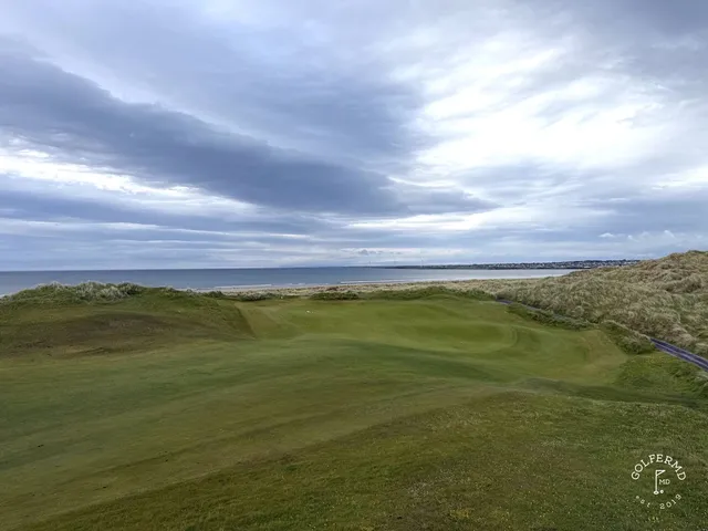 A wide fairway at Enniscrone, with the dunes and the bay in the distance.