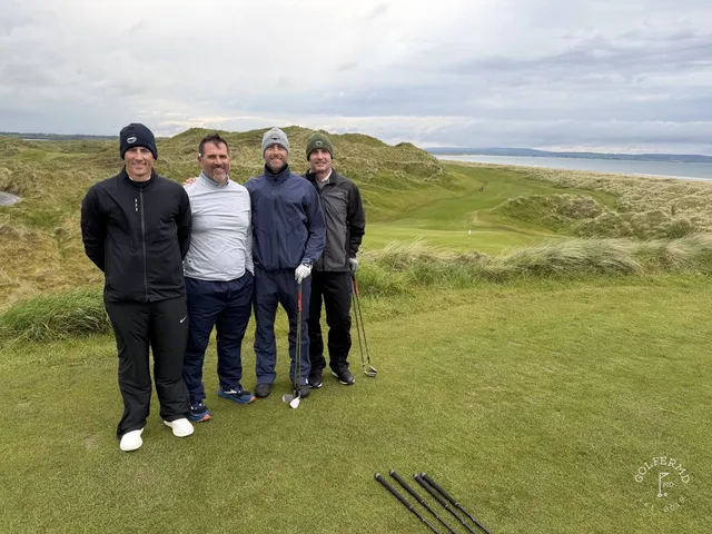 A green and flagstick at Enniscrone, with a deep bunker in front and the bay beyond.