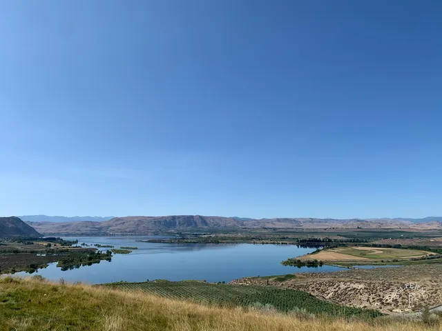 A tee view at Gamble Sands under the clouds, with bunkers beside the fairway and the green in the distance.