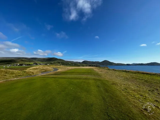 A fairway at Hogs Head with a bunker along one side and the water ahead.
