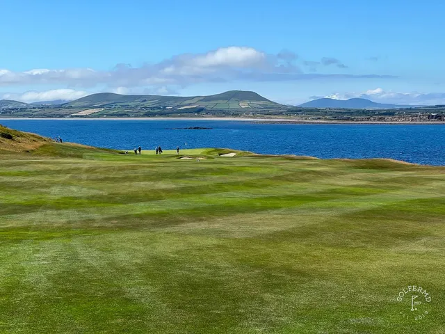 A green and flagstick at Hogs Head, with a bunker short of the green and the water beyond.