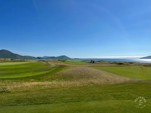 A fairway at Hogs Head with a bunker in the foreground and the bay beyond.