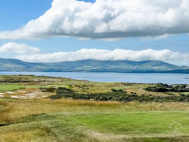 A green and flagstick at Hogs Head, seen from a rise above the hole.