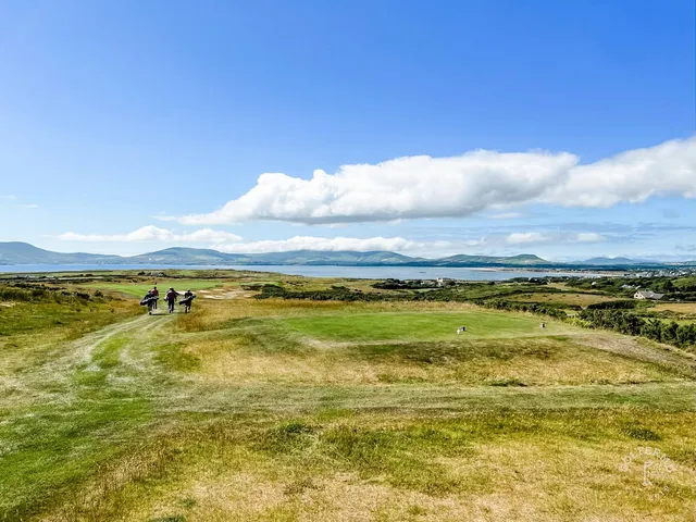 A close view of a flagstick at Hogs Head, with the Atlantic filling the background.