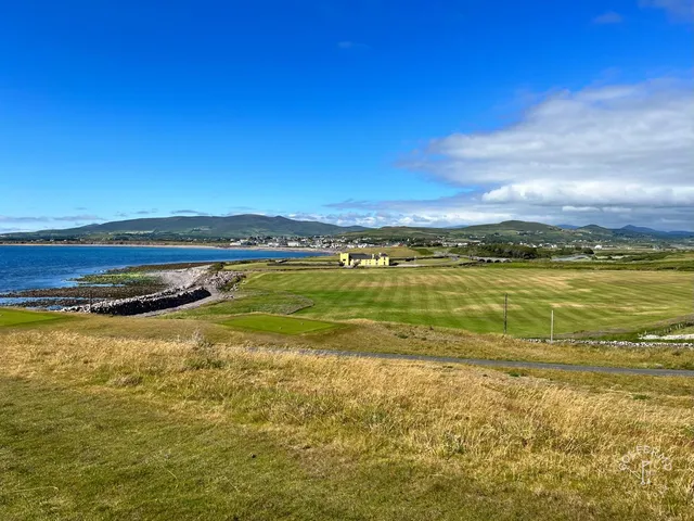 A wide fairway at Hogs Head dropping toward the water.