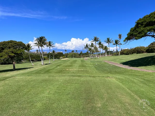 A fairway at Kaanapali's Kai Course running toward the ocean, with palm trees along the hole.