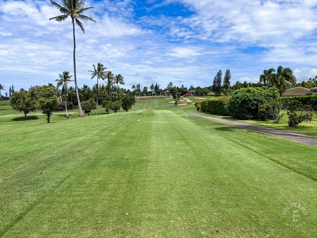 A wide fairway at the Royal Course, with the ocean in the distance.