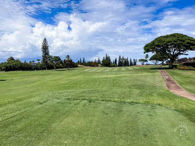 A group posing for a photo at the Royal Course, with the ocean behind them.