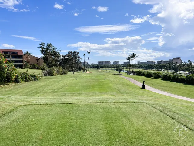 A green and flagstick at the Royal Course, with a large sand bunker wrapping the front.