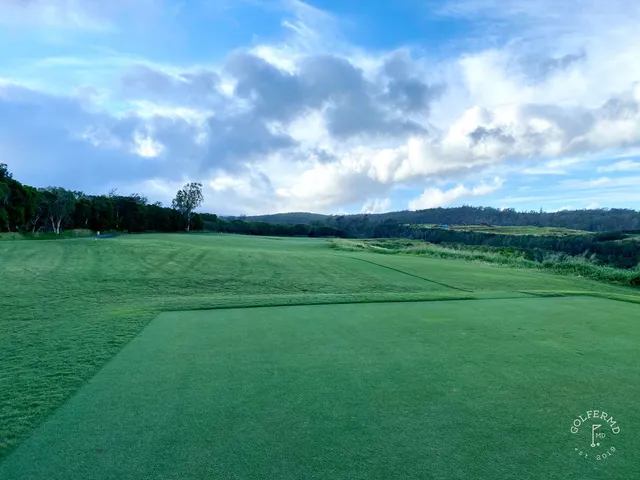 A fairway at the Plantation Course with sandy ground and the coast beyond.