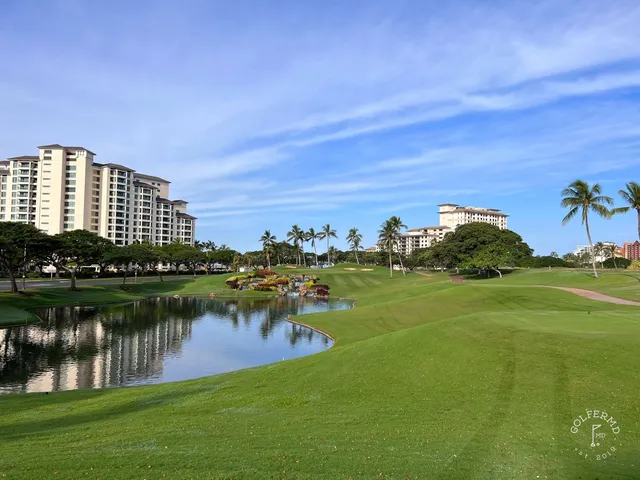 A fairway at Ko Olina with a sand bunker in the foreground and palm trees along the right side.
