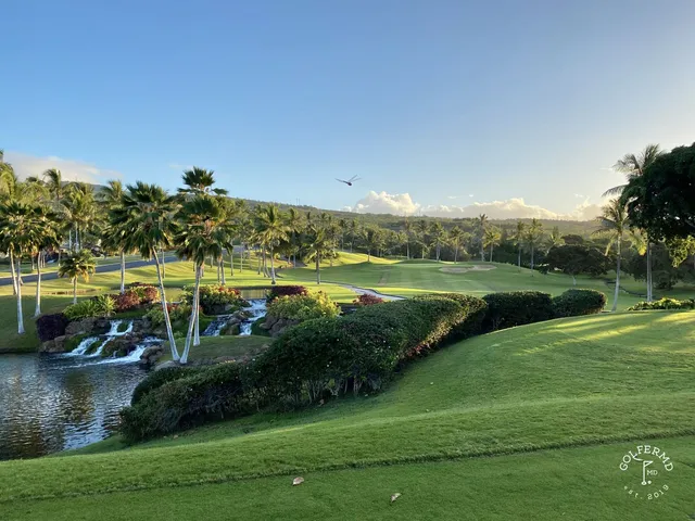 A fairway at Ko Olina running between palm trees toward the ocean.