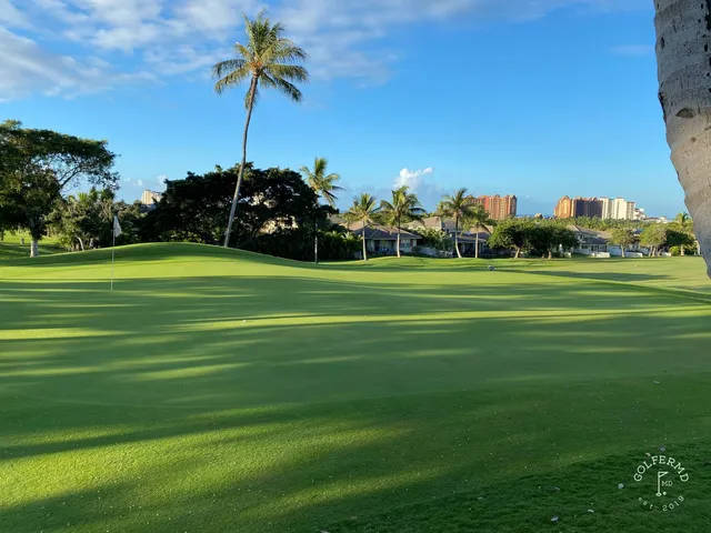 A wide fairway at Ko Olina, with the ocean visible beyond the palm trees.