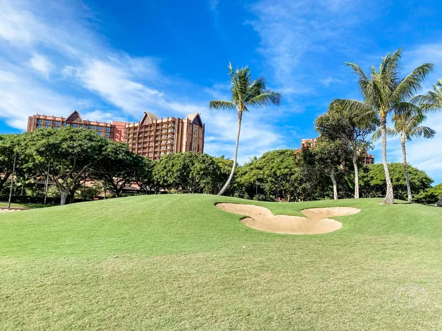 A fairway at Ko Olina running toward the ocean, with sand bunkers along the left side.