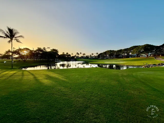 A green and flagstick at Ko Olina, with a sand bunker wrapping the front of the green.